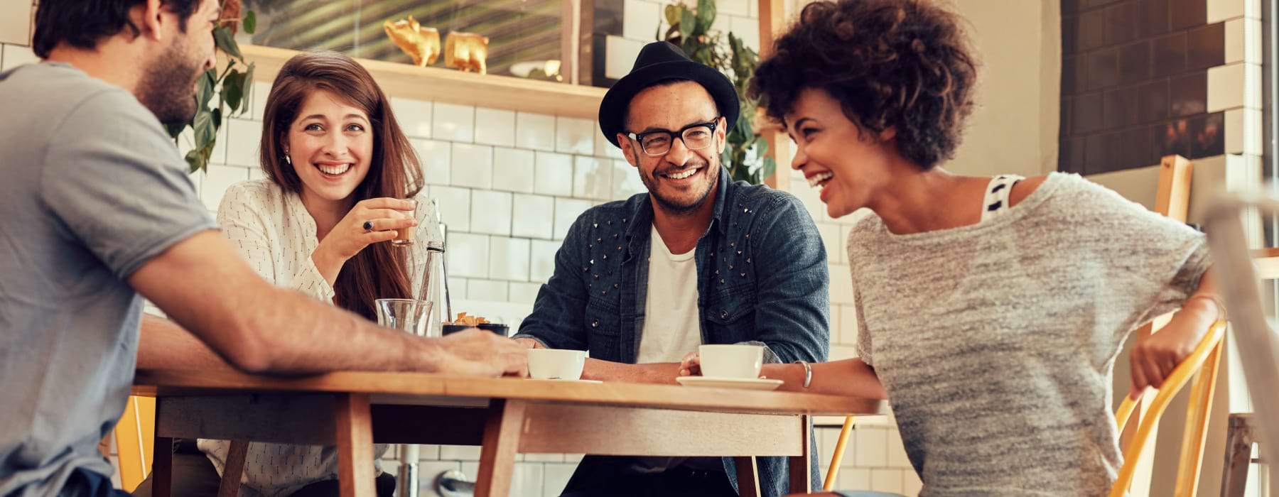 several people smiling drinking coffee  3 bedroom townhouse rentals Frederick MD The Foundry at Renn Quarter