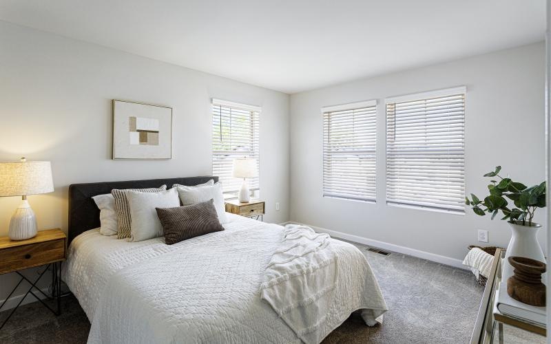carpeted bedroom with large windows