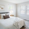 carpeted bedroom with large windows