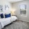 a bedroom with a bed and lamps